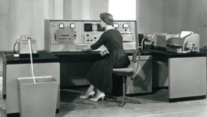 black and white phot with woman controlling big 'radio' type box!